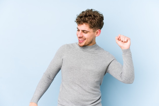 Young blond curly hair caucasian man dancing and having fun.