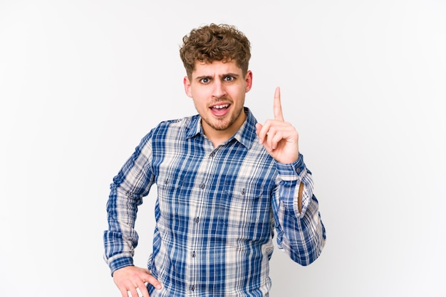 Young blond curly hair caucasian man isolated having an idea, inspiration concept.