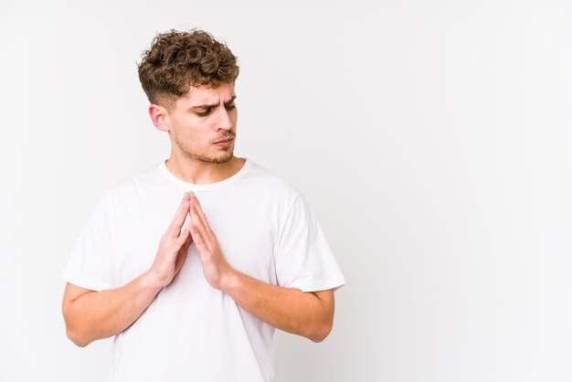 Young blond curly hair caucasian man isolated making up plan in mind, setting up an idea.