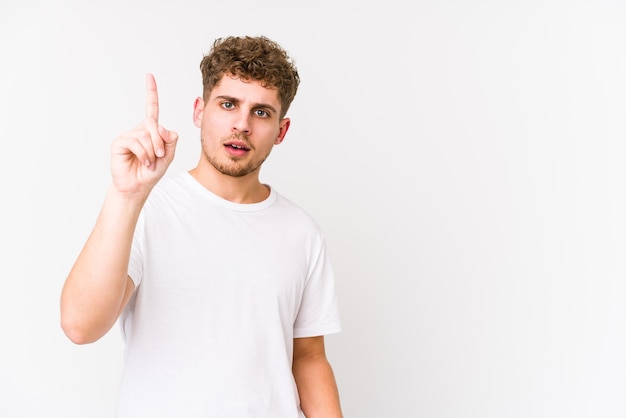 Young blond curly hair caucasian man isolated showing number one with finger.