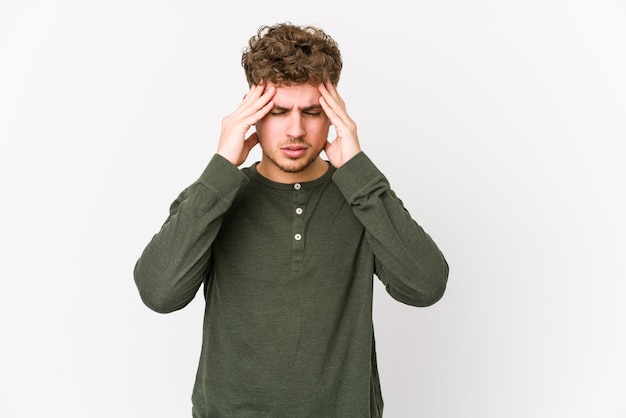 Young blond curly hair caucasian man isolated touching temples and having headache.