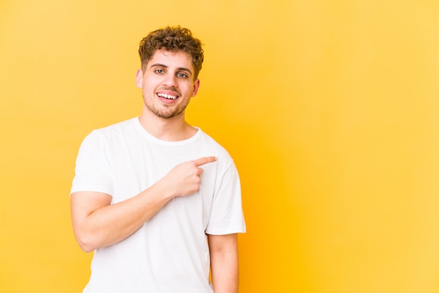 young blond curly man pointing to side