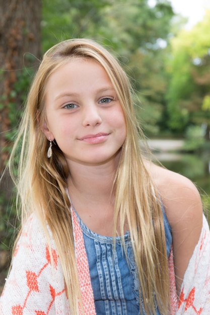 Young blond girl smiling at the camera