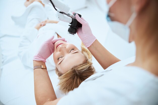 Young blond woman getting a professional skin treatment