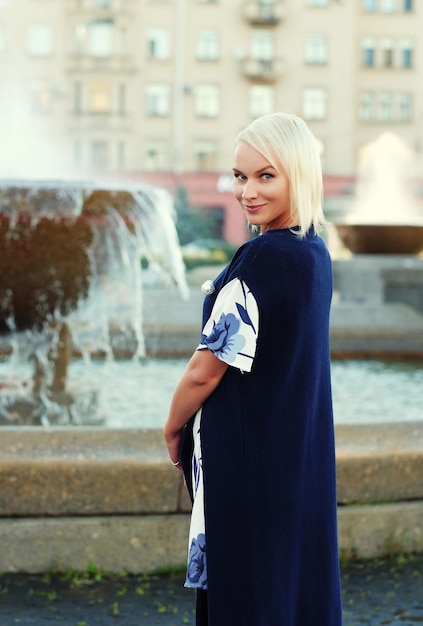 young blond woman walking on the street