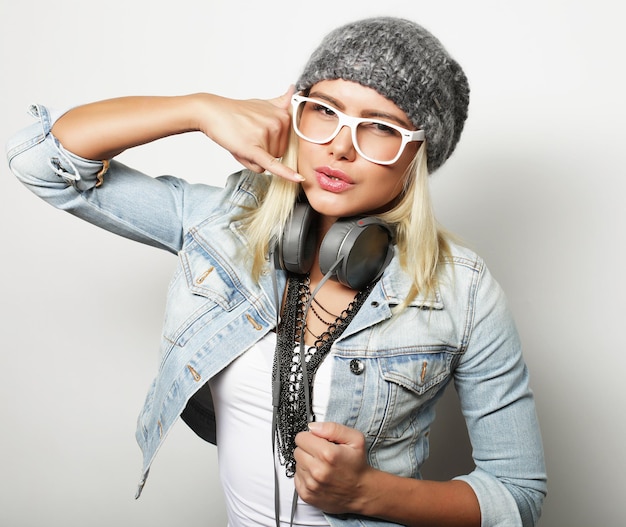 Young blond woman wearing casual clothes hipster style over white background