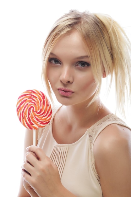 Young blond woman with candy isolated on white