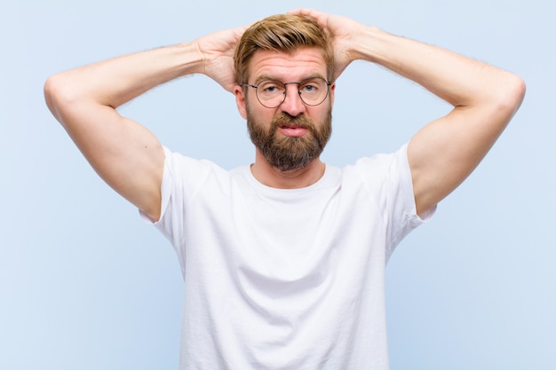 Young blonde adult man feeling frustrated and annoyed, sick and tired of failure, fed-up with dull, boring tasks