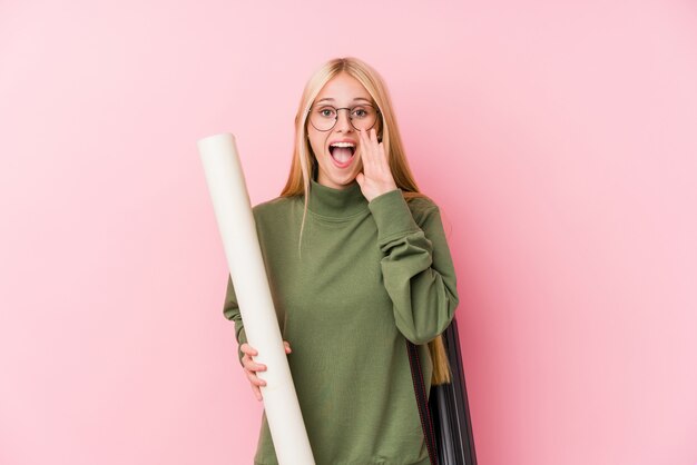 Young blonde architecture student shouting excited to front.