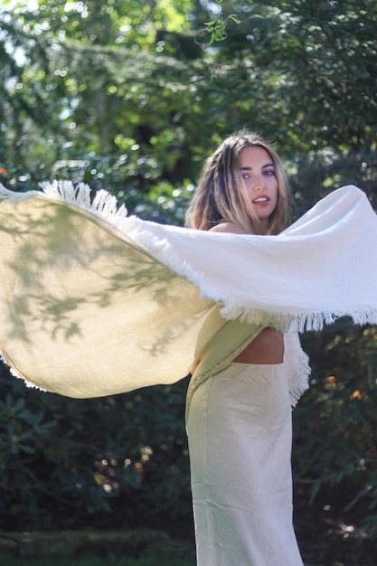 Young blonde boho chic woman with natural beige outfit