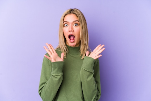 Young blonde caucasian woman isolated celebrating a victory or success, he is surprised and shocked.