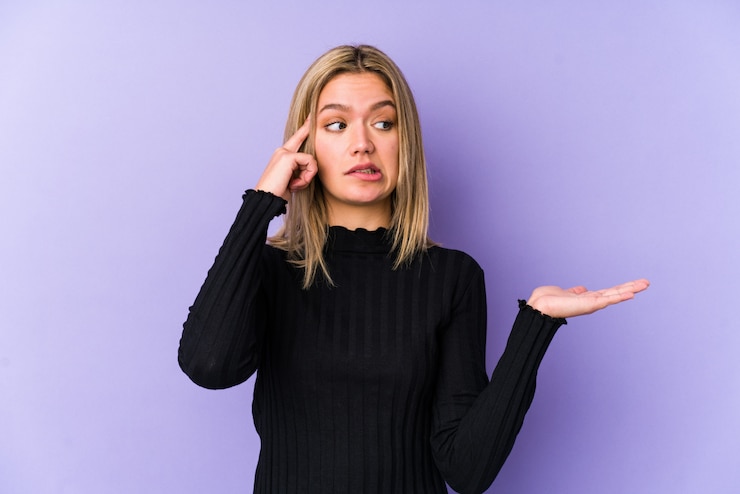 Photo young blonde caucasian woman isolated holding and showing a product on hand.