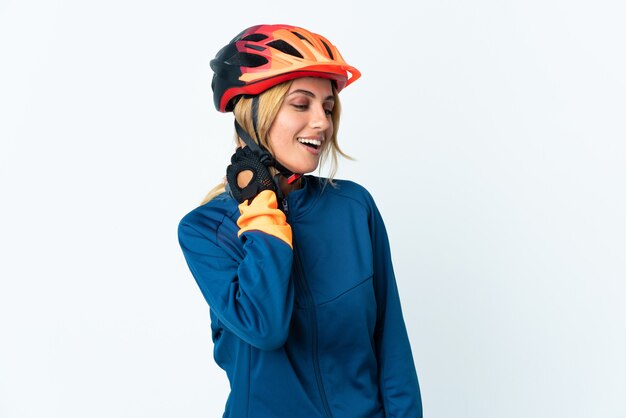 Young blonde cyclist woman isolated laughing