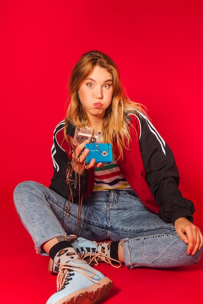 Young blonde girl in 90s retro style clothes