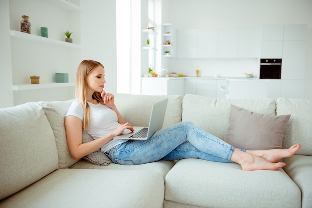 Young blonde girl lying on the sofa