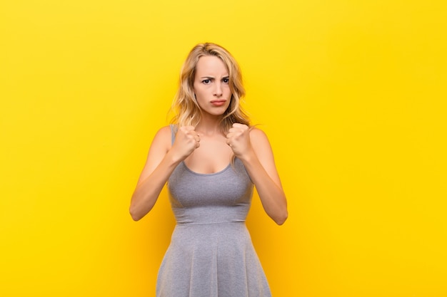 young blonde girl ready to fight in boxing position