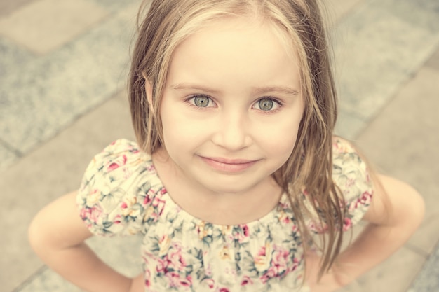 Young blonde girl smiling shyly