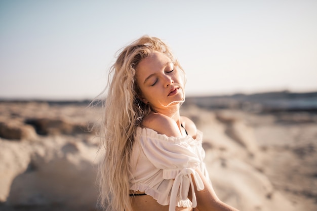 Young blonde girl in summer