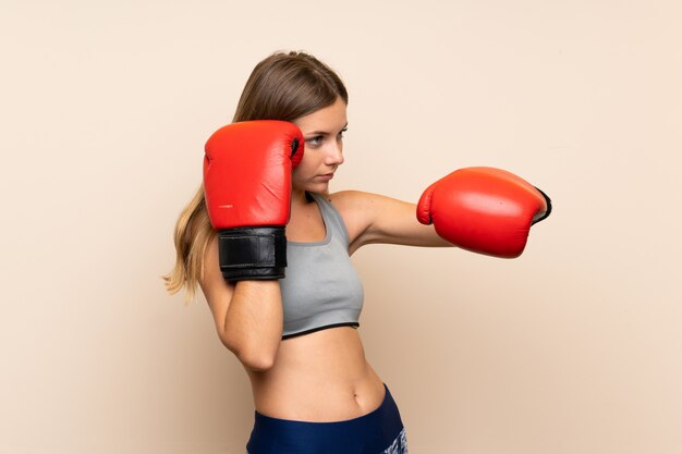 Young blonde girl with boxing gloves