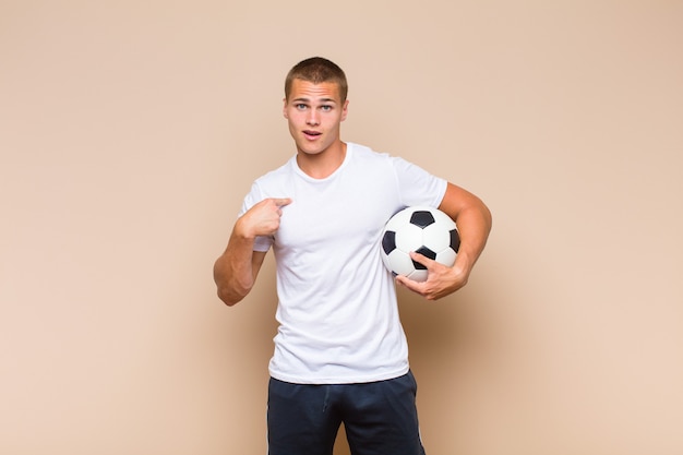 Young blonde man feeling happy