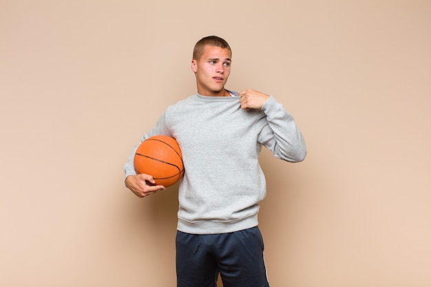 Young blonde man feeling stressed, anxious, tired and frustrated, pulling shirt neck, looking frustrated with problem