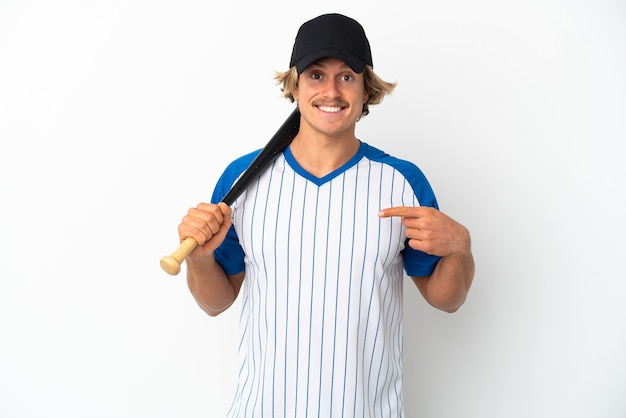 Young blonde man isolated on white wall playing baseball and with surprise facial expression