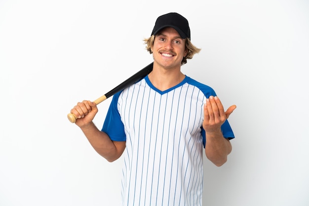 Young blonde man playing baseball isolated on white background inviting to come with hand. Happy that you came