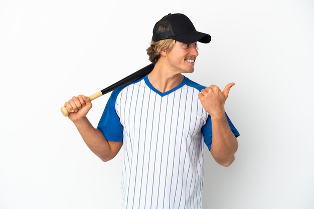 Young blonde man playing baseball isolated on white background pointing to the side to present a product