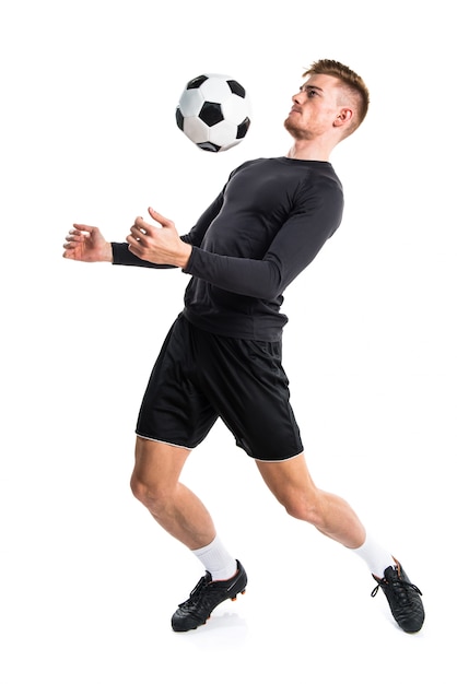 Young blonde man playing football