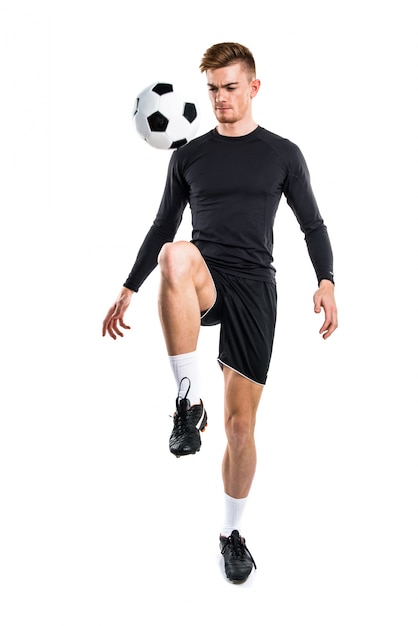 Young blonde man playing football
