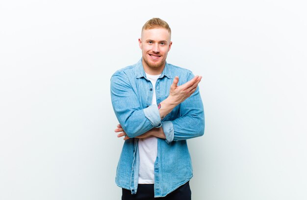 young blonde man showing something with the hand