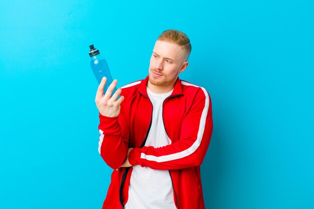 Young blonde man wearing sports clothes