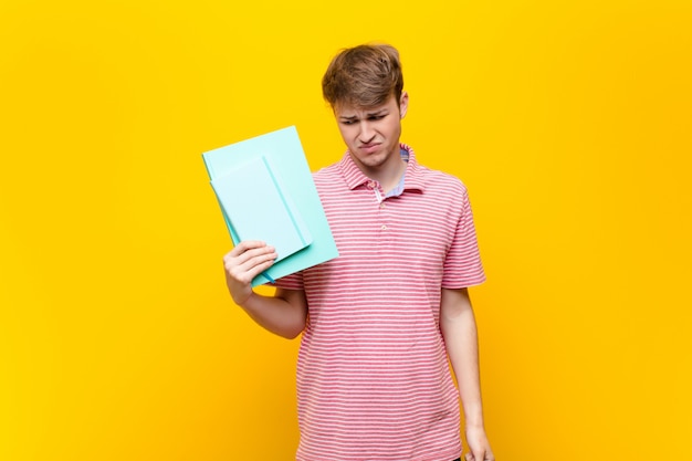 Young blonde man with book