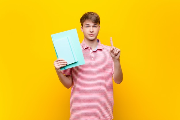 Young blonde man with book