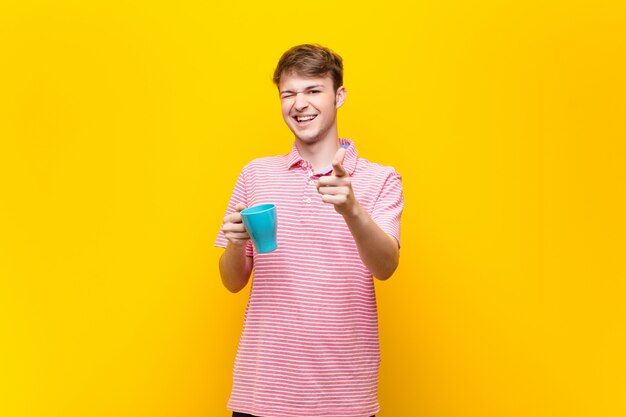 Young blonde man with a coffee cup