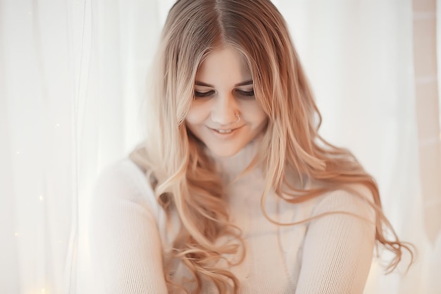 young blonde posing at home beautiful long hair