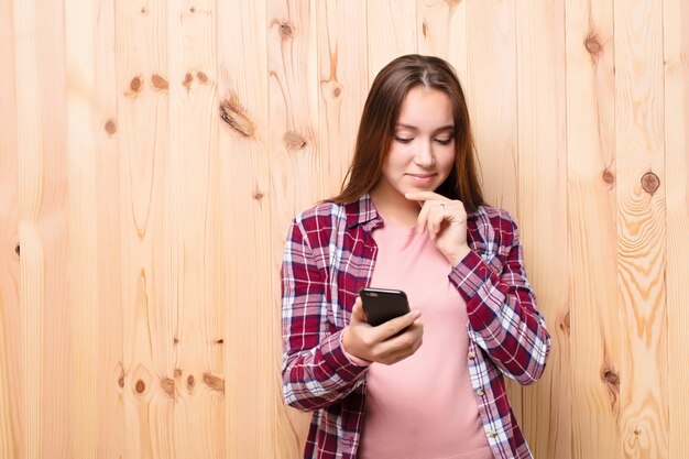 Young blonde pretty girl using a smartphone