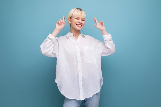 Young blonde secretary woman dressed in a white shirt gesticulates in different directions with her