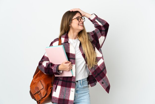 Young blonde student woman isolated smiling a lot