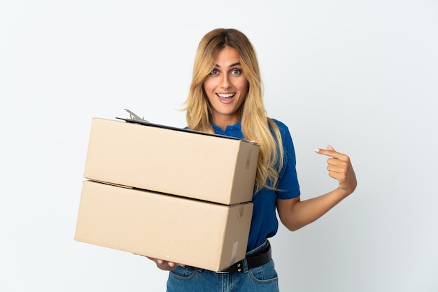 Young blonde Uruguayan delivery woman isolated on white wall with surprise facial expression