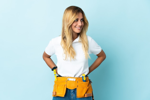 Young blonde Uruguayan electrician woman blue looking side