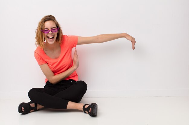 Young blonde woman  against  wall