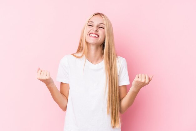 Young blonde woman cheering carefree and excited