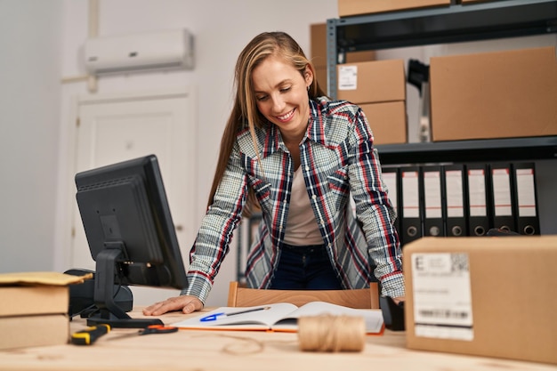 Young blonde woman ecommerce business worker smiling confident standing at office