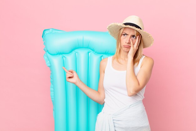 Young blonde woman feeling bored, frustrated and sleepy after a tiresome