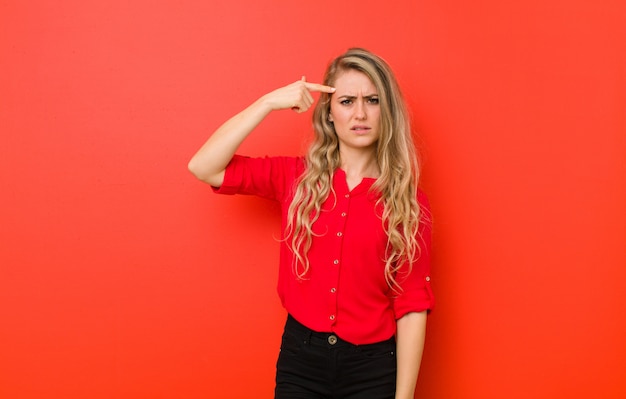 Young blonde woman feeling confused and puzzled