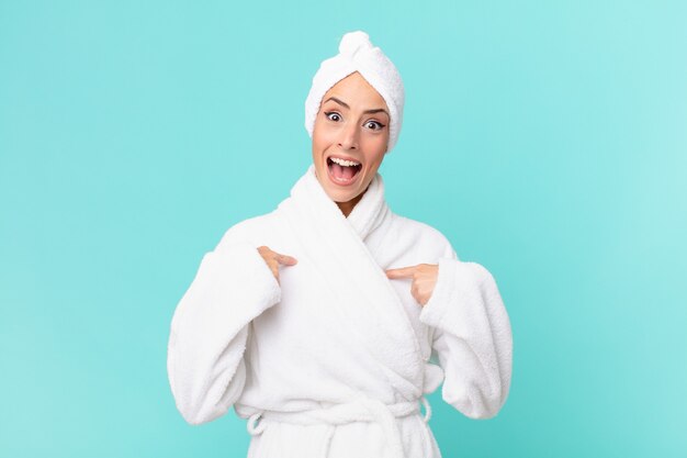 Young blonde woman feeling happy and pointing to self with an excited. shower concept