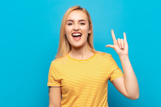 Young blonde woman feeling happy