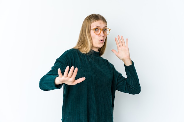 Young blonde woman feeling shocked