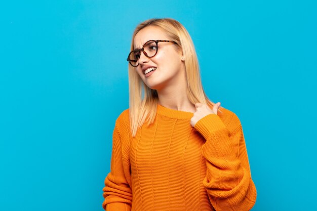 Young blonde woman feeling stressed, anxious, tired and frustrated, pulling shirt neck, looking frustrated with problem